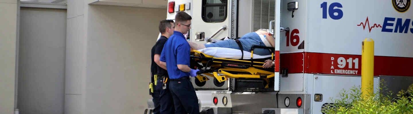 Image of paramedics taking someone out of an ambulance that has suffered a brain injury, representing the need for TBI lawyers in WV when facing an unimaginable battle to recover the compensation you deserve.
